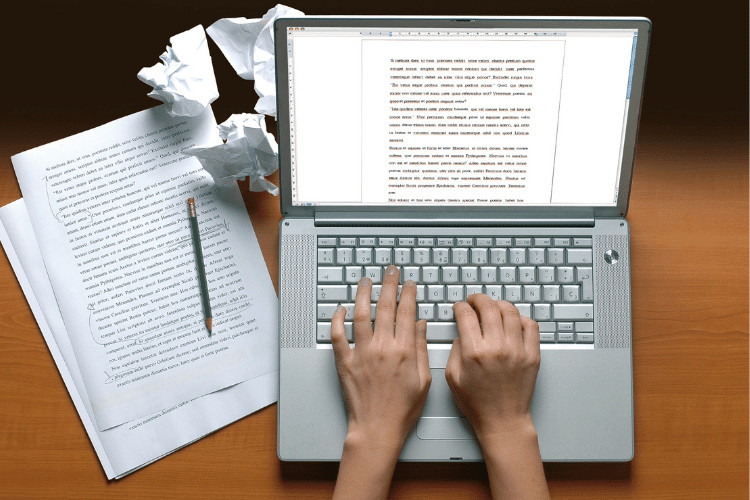 A content writer working on laptop, Top view