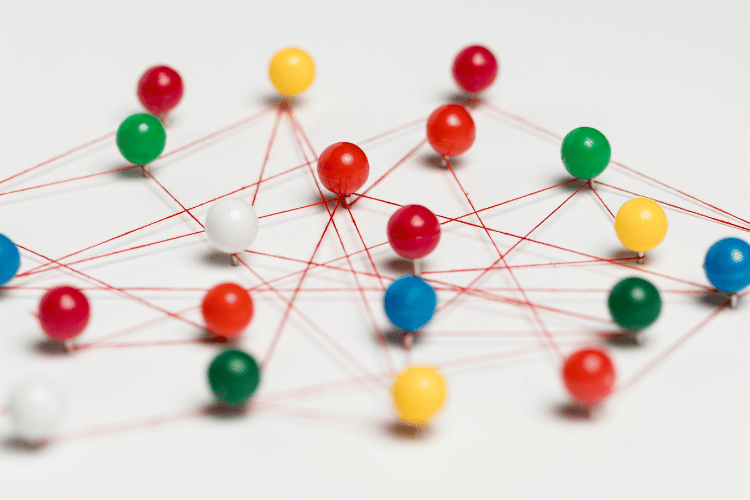 Colorful pushpins with thread route map